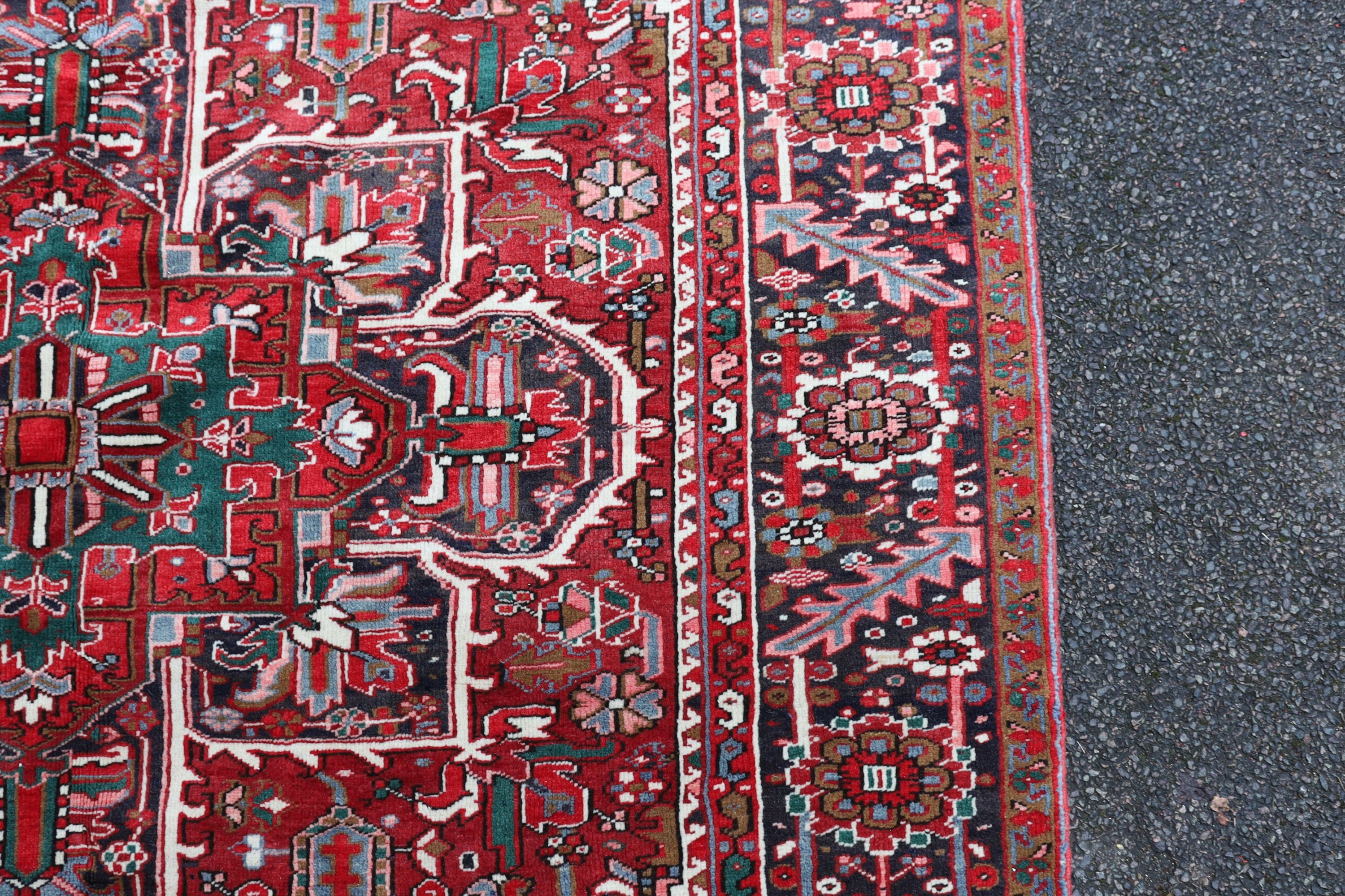 A Heriz red ground carpet, 324 x 243cm.